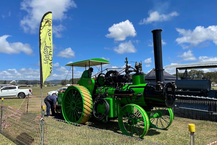 A bright green steam powered tractor 