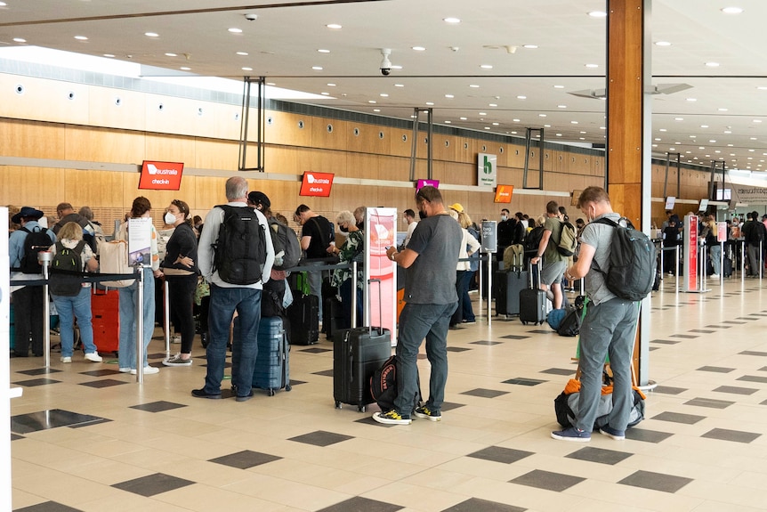 Travellers at Hobart airport's check in area.