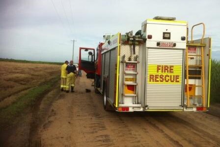 A fire engine at the scene of a light plane crash where two men died north of Bundaberg.