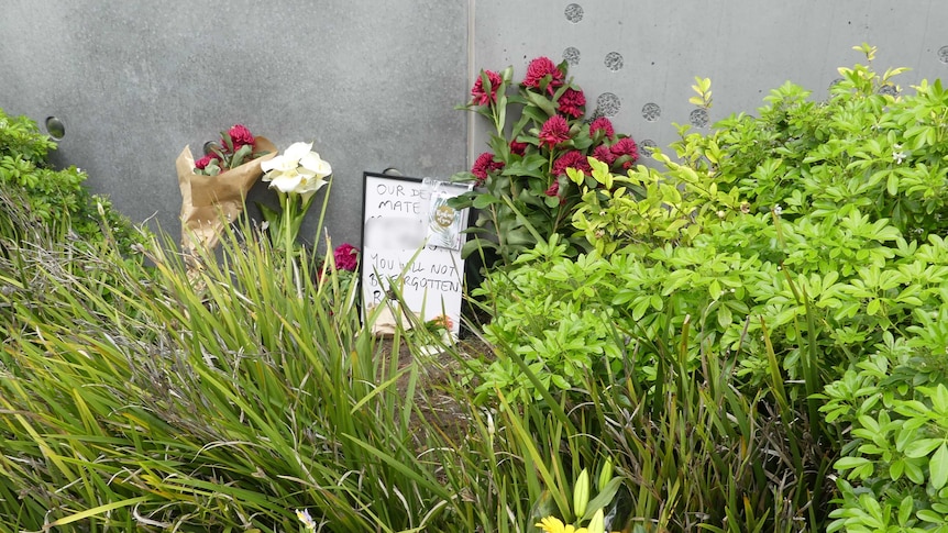 Tributes have been left in bushes for a man who died outside Hobart's main hospital
