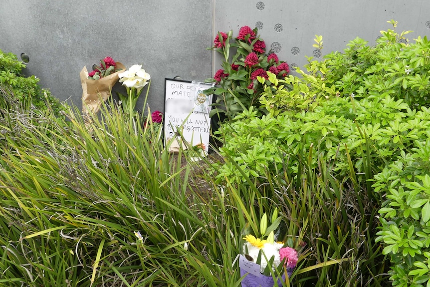 Tributes have been left in bushes for a man who died outside Hobart's main hospital