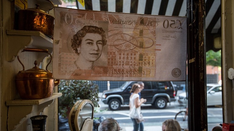Queen Elizabeth is displayed on a flag of a 50 pound note at Myers of Keswick, a British grocery store