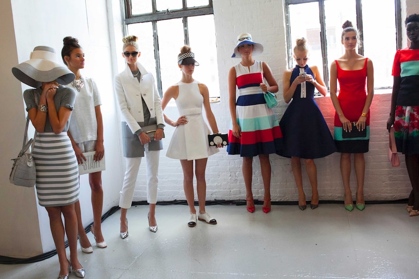 Models line up backstage before the Kate Spade Spring/Summer 2014 collection.