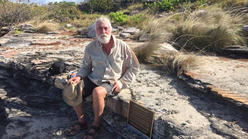 Mike Owens sitting on a rock.