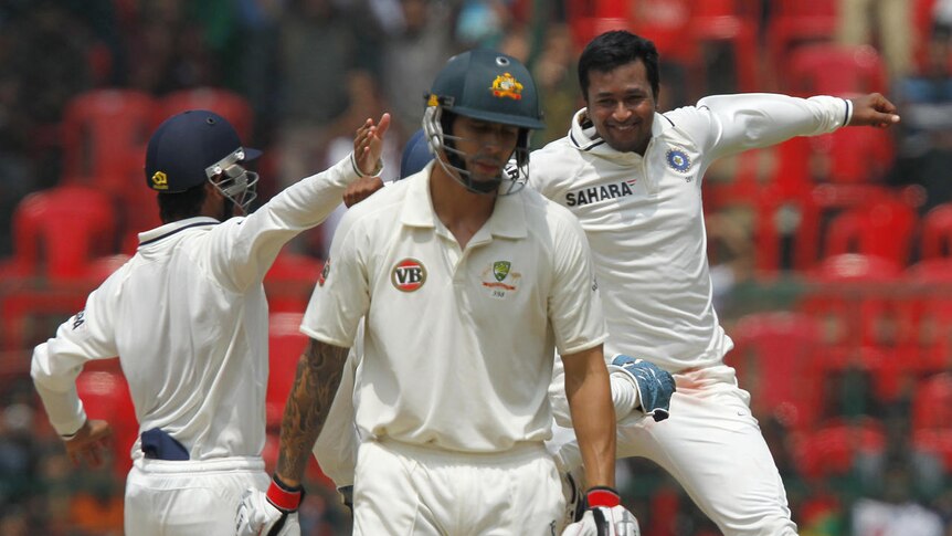 In a spin ... Pragyan Ojha rejoices after dismissing Mitchell Johnson for a duck.