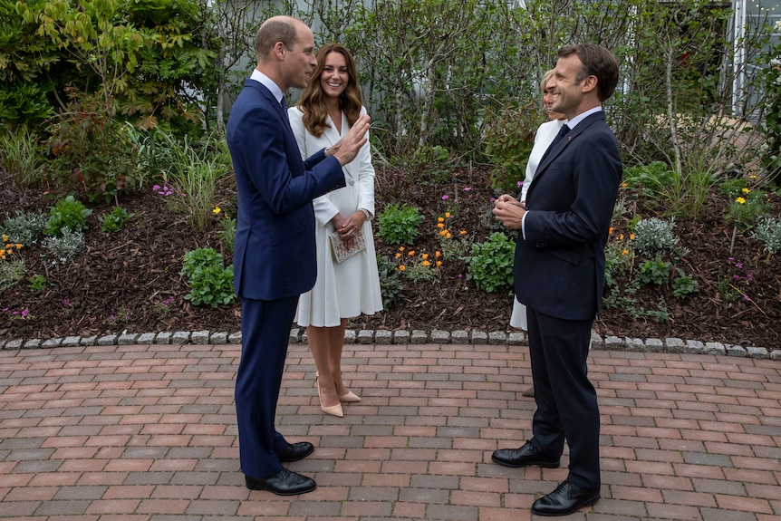 Britain's Prince William and Kate, the Duchess of Cambridge speak to French President Emmanuel Macron.