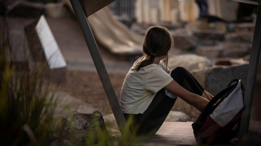 Girl looking sad at playground