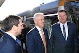 Matthew Guy, Malcolm Turnbull and Liberal candidate for Frankston Michael Michael Lamb stand on beside a train.