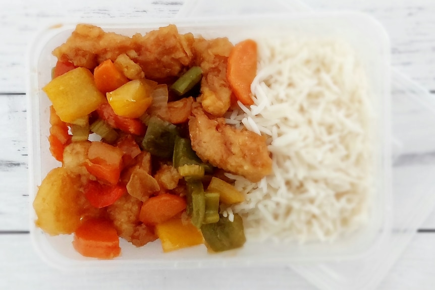 A sweet and sour chicken meal in a plastic container