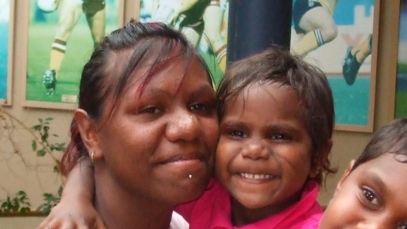 Four-year-old Naylor Walden hugs a family member