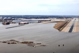 An aerial photo shows a military airport's landing strip partially flooded.