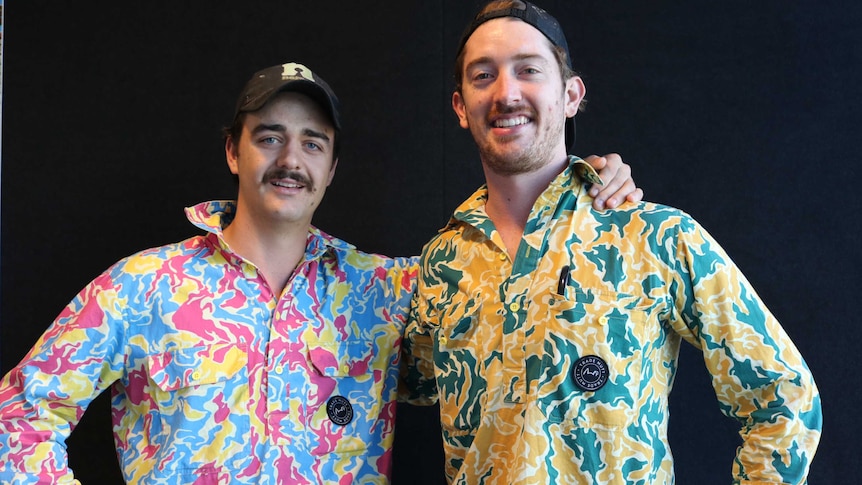 Two young men in colourful camouflage work shirts.