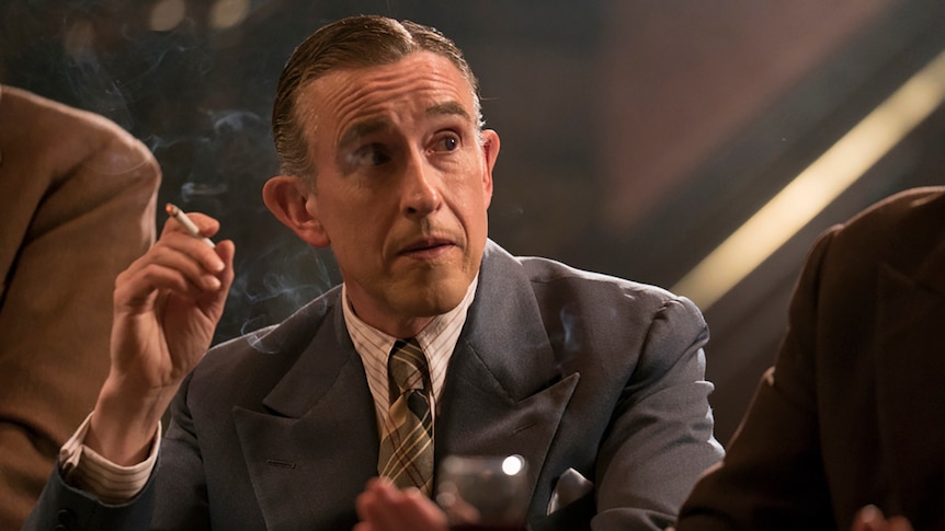 Colour close-up still of close-up of Steve Coogan smoking in 2018 film Stan and Ollie.
