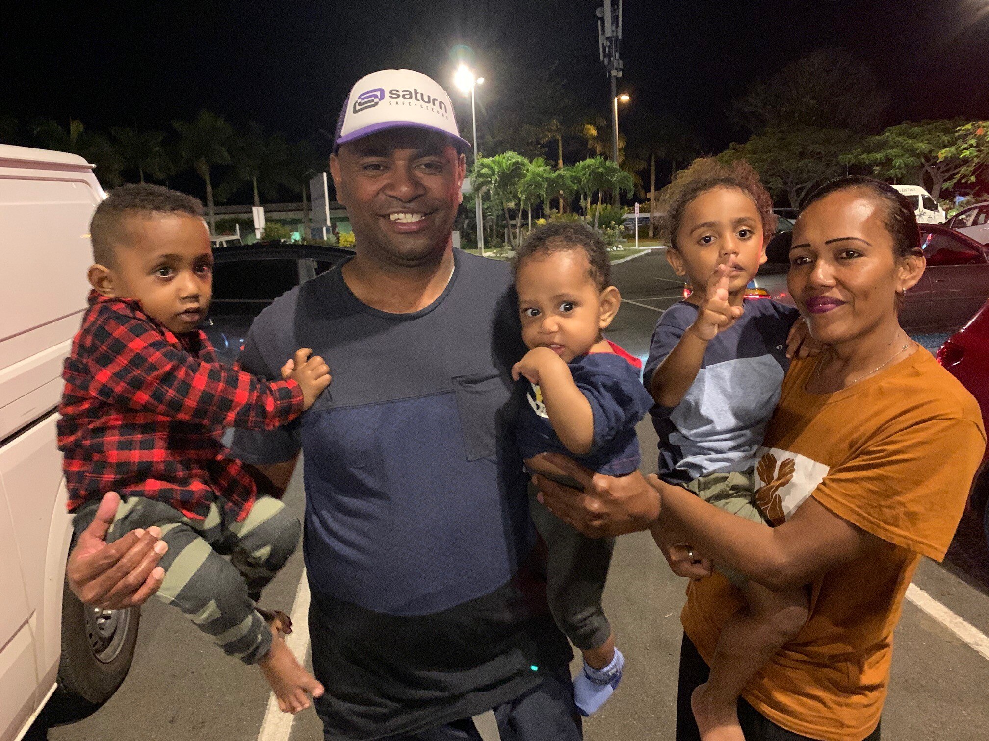 Family photo of parents with three boys