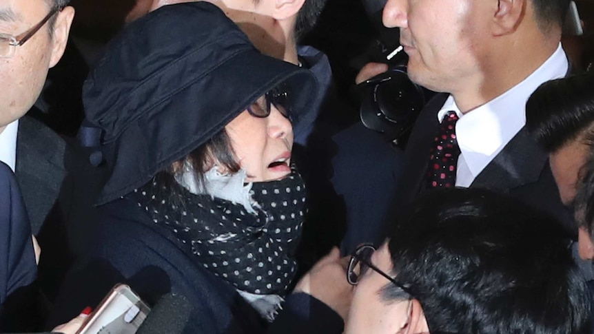 Choi Soon-sil, centre left, is surrounded by officers and media upon her arrival at the prosecutors office in Seoul.