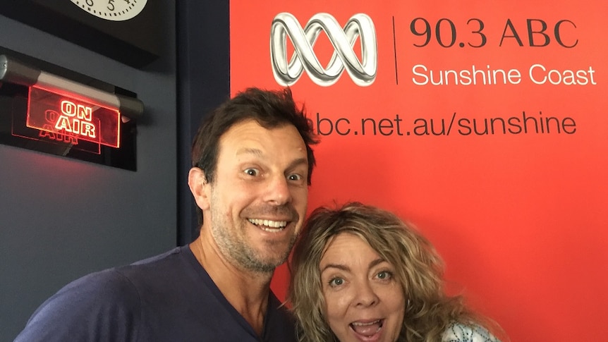 Man and woman smiling in ABC Sunshine Coast studio