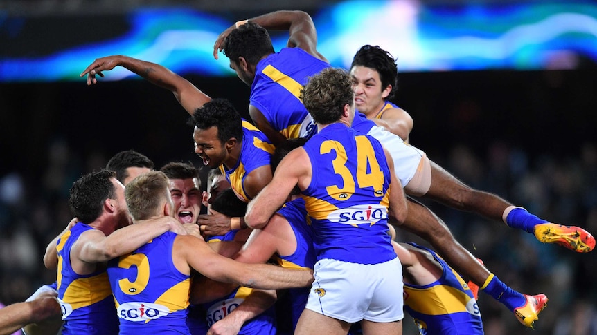 Eagles players pile on after Jeremy McGovern's winning goal