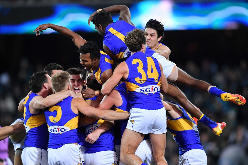 Eagles players pile on after Jeremy McGovern's winning goal