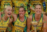 Australia's Diamonds celebrate with the Constellation Cup as confetti falls on them.