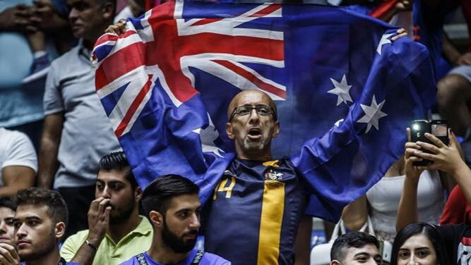 Osman holds an Australian  flag above his head at the Basketball FIBA Asian Cup basketball tournament in Beirut in 2017.