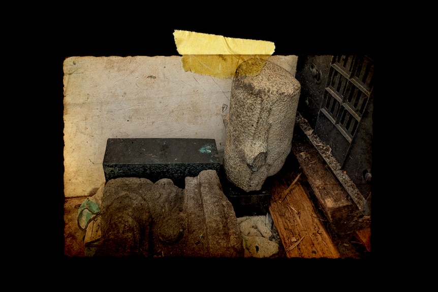 A Lord Vishnu stone sculpture sits gathering dust in garage.