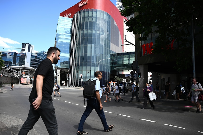 Men cross the street. 