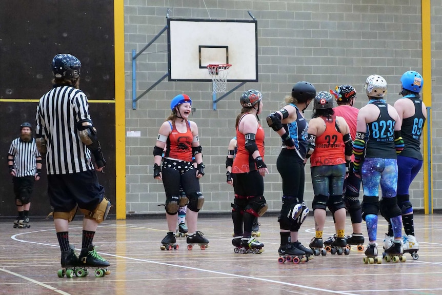 One player laughs as they stand on the court between competing.