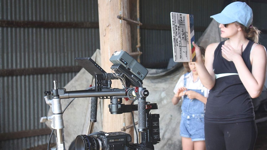 Producer Demi Bird holds a movie clapper near a camera on the set of the film, Jade, at Haigslea, west of Brisbane.