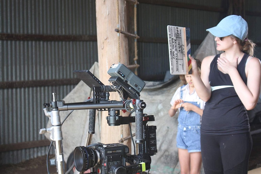 Producer Demi Bird holds a movie clapper near a camera on the set of the film, Jade, at Haigslea, west of Brisbane.
