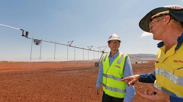 Agriculture Minister Terry Redman and Rio's Allan Jackson next to an irrigator in the Pilbara