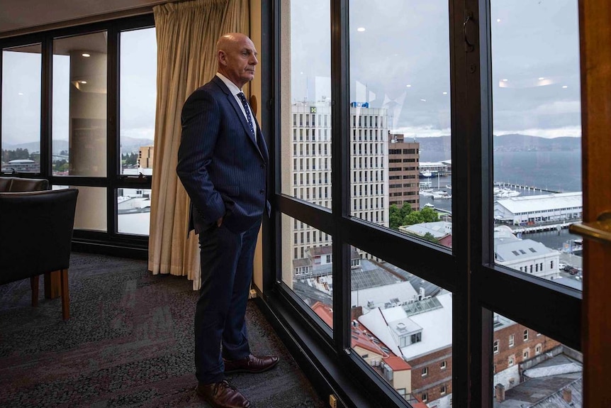 Tasmanian Premier Peter Gutwein looks out a window in his office.