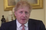 Boris Johnson looks at the camera while wearing a black suit.