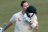 An Australian male batter kisses his helmet after scoring a Test century against Sri Lanka.