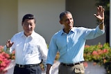 Xi Jinping and Barack Obama wave as they talk a walk at the Annenberg Retreat at Sunnylands