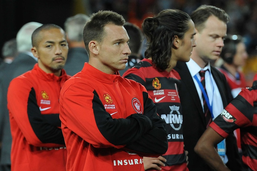 A dejected Wanderers' Brendon Santalab (2L) after the 2014 A-League Grand Final loss to Brisbane