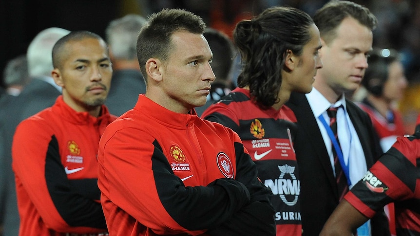 A dejected Wanderers' Brendon Santalab (2L) after the 2014 A-League Grand Final loss to Brisbane
