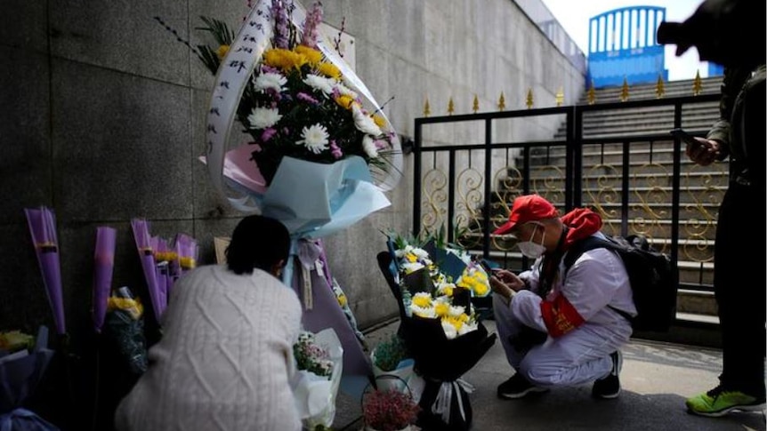 People lay flowers to remember the dead.