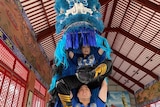 Anna Duong and Albert Nguyen are dressed in a blue lion dancing costume.