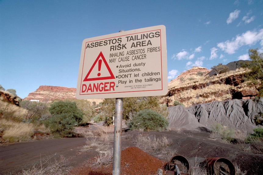 Sign with asbestos waste warning at Wittenoom Gorge on site.