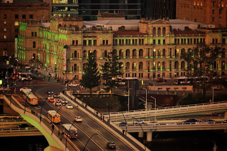 Treasury Casino building and traffic on South East freeway in Brisbane at sunset.