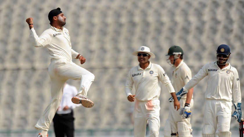 Indian spinner Harbhajan Singh (L) jumps for joy after taking an Australian wicket in Mohali.