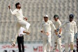 Indian spinner Harbhajan Singh (L) jumps for joy after taking an Australian wicket in Mohali.