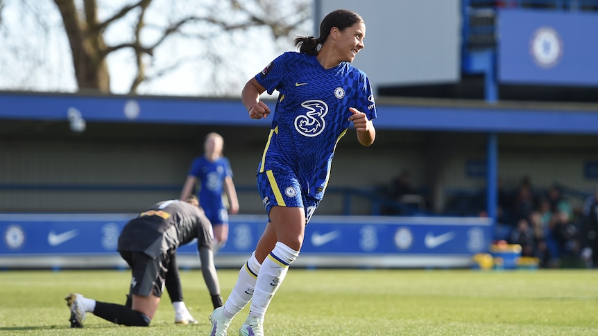 Chelsea's Sam Kerr jogs away with a smile as Leicester's goalkeeper is slumped on the ground.