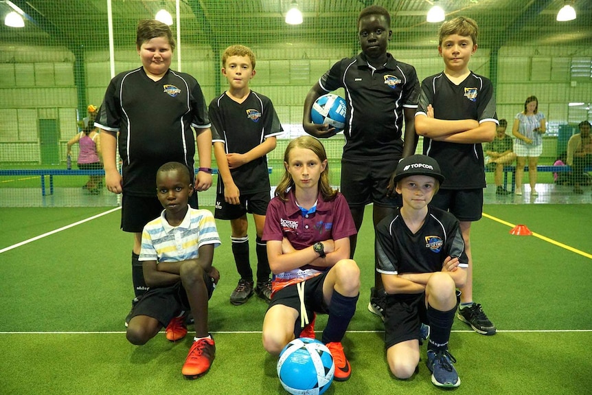 Young soccer players bunched together in a team squad pose