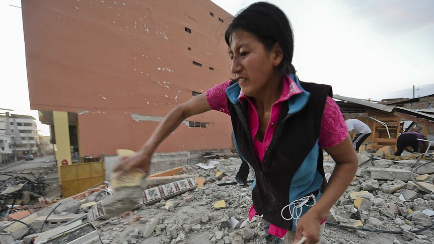 Ecuadorean Veronica Paladines, removes rubble in search for her husband
