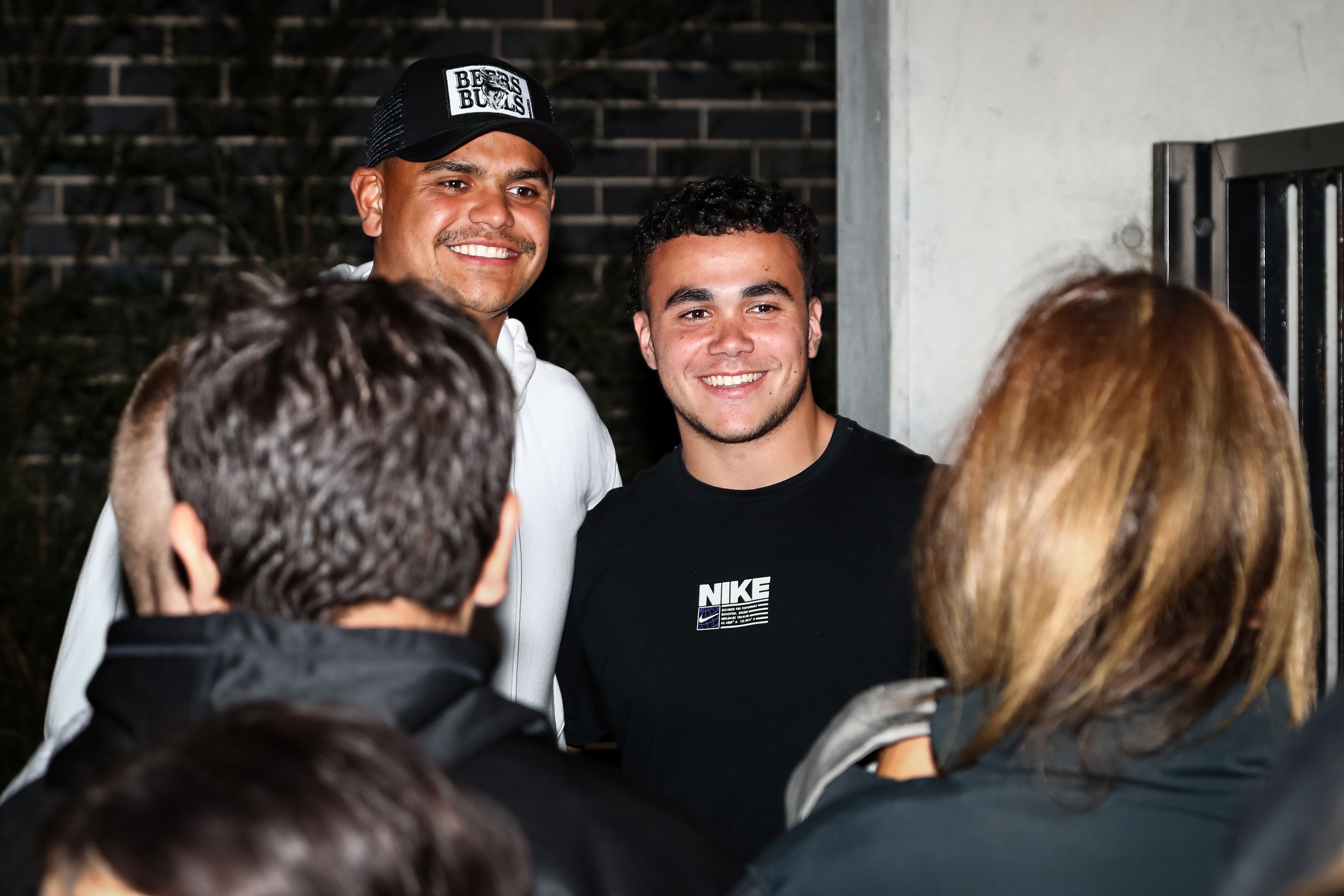 Two men standing side by side while smiling for a photo