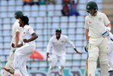 Lakshan Sandakan celebrates the wicket of Mitchell Starc