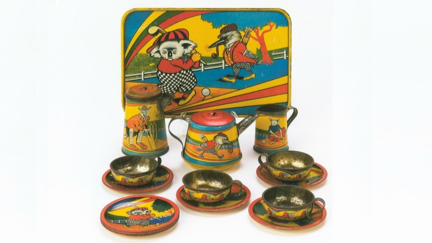 A vintage toy tea set including a tray, kettle, teapot, cups and saucers, illustrated with Australian animals in garish colours