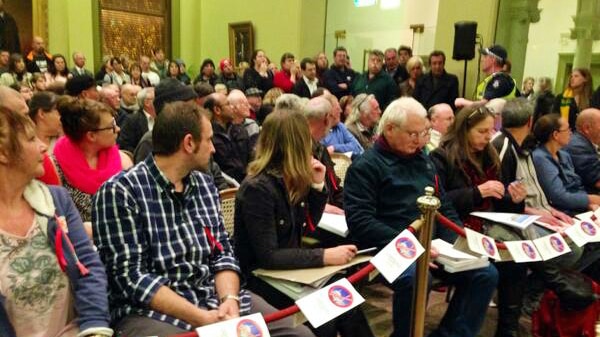 Anti-mosque campaigners hold fliers explaining their opposition to at a Bendigo Council meeting.