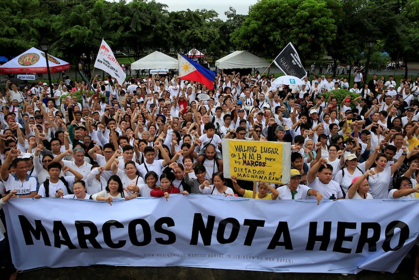 Protestors carry a sign